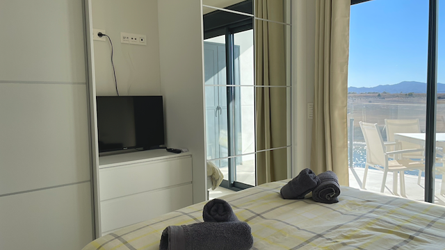 A bedroom, with the course through the glass